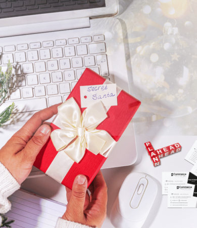 Holiday-themed workspace with a laptop displaying a digital marketing dashboard, surrounded by festive decorations like gift boxes, a small Christmas tree, and fairy lights